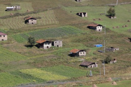 These houses on the side of a hill near Shenako are where the animals are kept for the winter. Three families in Shenako remain for the winter to look after the flocks.